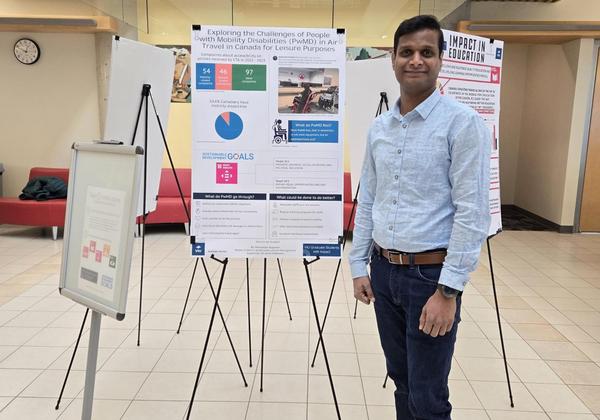 Student standing in front of poster