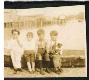 Boys sitting by marina, QFN Archives