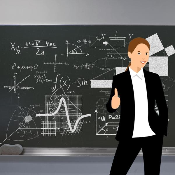 Cartoon picture of a teacher in front of a black board 