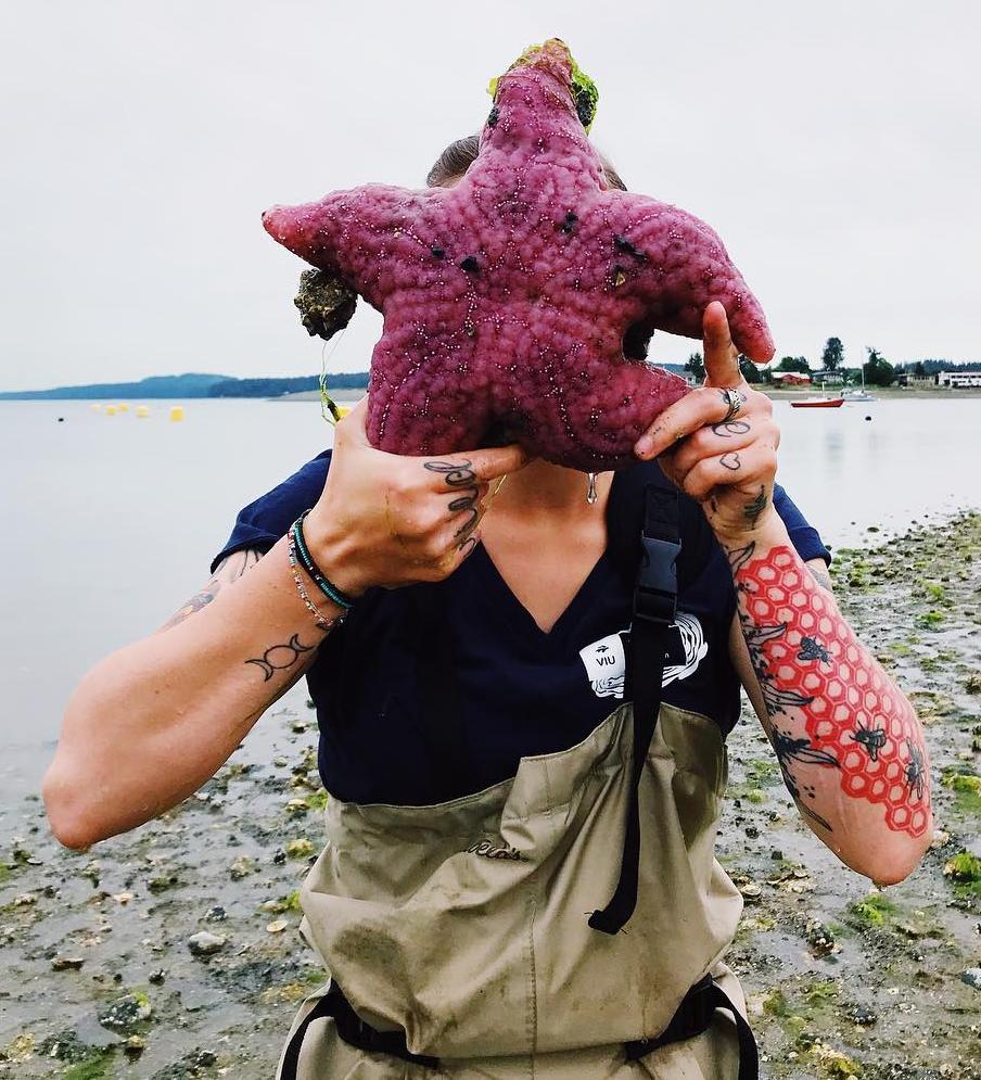 Person with seastar in front of their face
