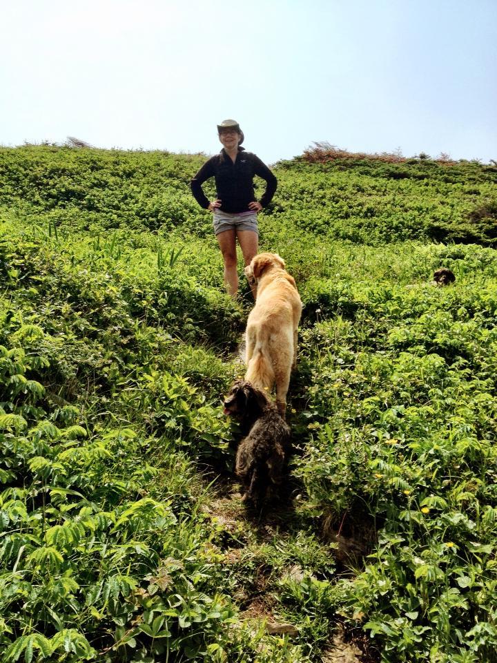 P. Wells in the field with her dog