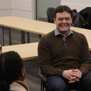 Alistair MacGregor speaking with a student