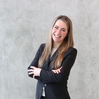 Gillian Robinson standing with folded arms.