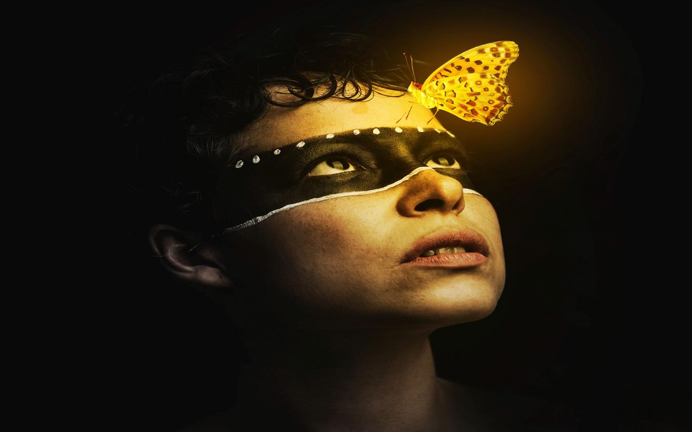 Woman looking up at butterfly